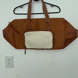 Duffle with faux shearling cosmetics pouch